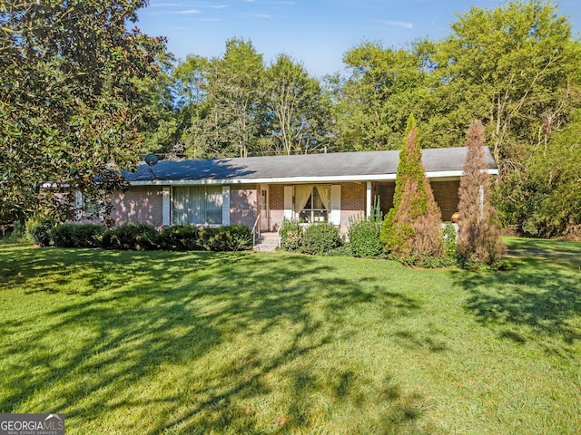 ranch-style home featuring a front yard