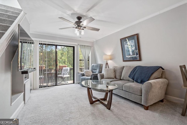 living room featuring ceiling fan, ornamental molding, and light colored carpet