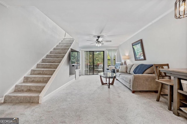 living room featuring ornamental molding, carpet, and ceiling fan