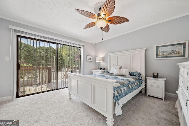 bedroom featuring ceiling fan, light carpet, access to outside, and a textured ceiling