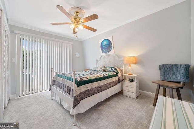 bedroom featuring ornamental molding, light colored carpet, and ceiling fan