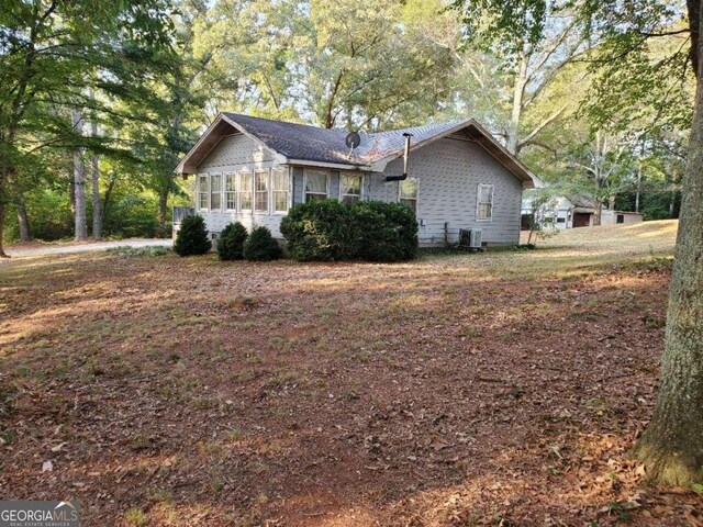 back of house with a deck