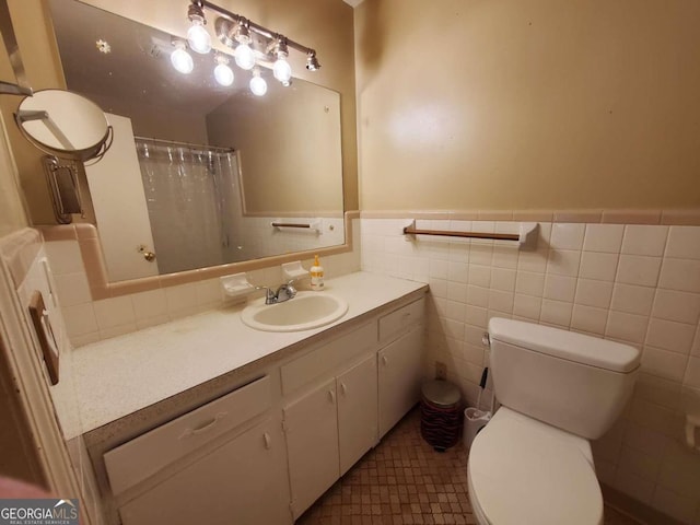 bathroom with tile walls, tile patterned floors, vanity, and toilet