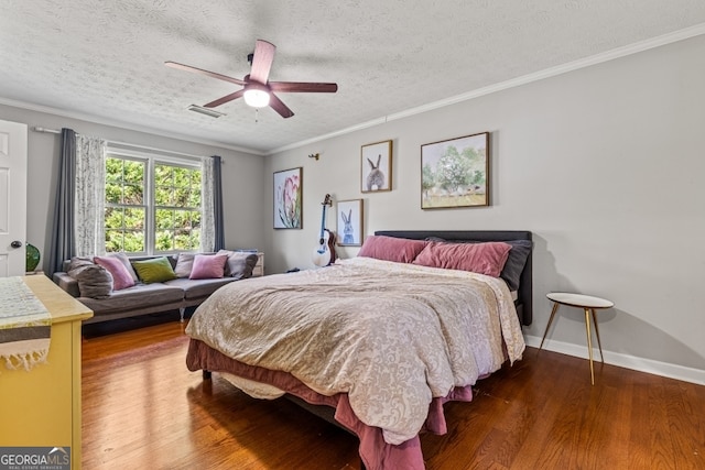 bedroom featuring ceiling fan, ornamental molding, a textured ceiling, and hardwood / wood-style floors