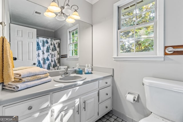 bathroom with a healthy amount of sunlight, vanity, toilet, and ornamental molding