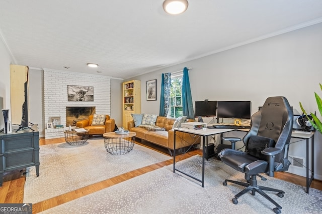 office with hardwood / wood-style floors, a fireplace, and crown molding