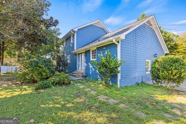 view of side of property featuring a yard