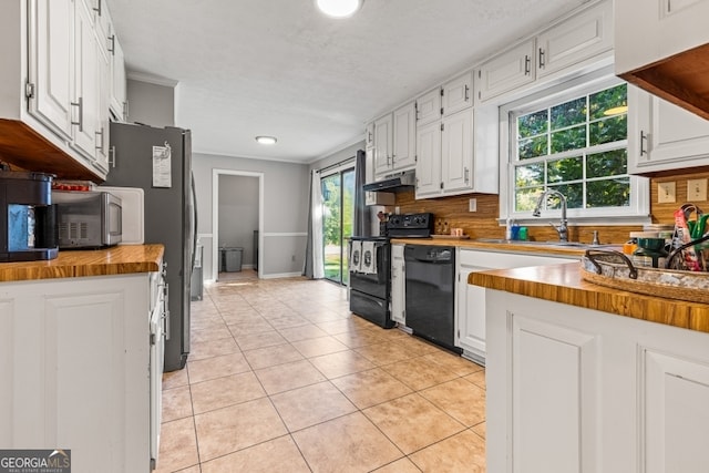 kitchen with white cabinets, black appliances, and butcher block countertops