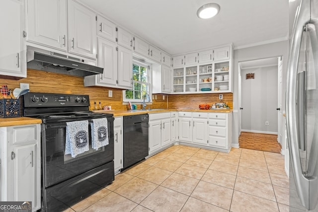 kitchen with white cabinets, crown molding, light tile patterned floors, and black appliances