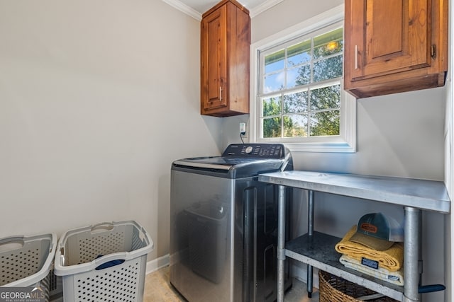 laundry room with washer / clothes dryer, cabinets, and ornamental molding