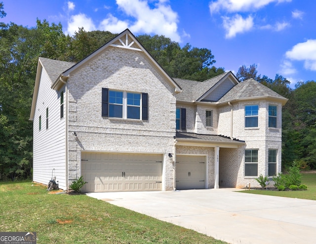 view of front of property with a front yard and a garage