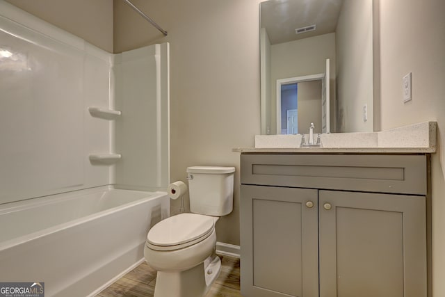 full bathroom with shower / bathtub combination, wood-type flooring, vanity, and toilet