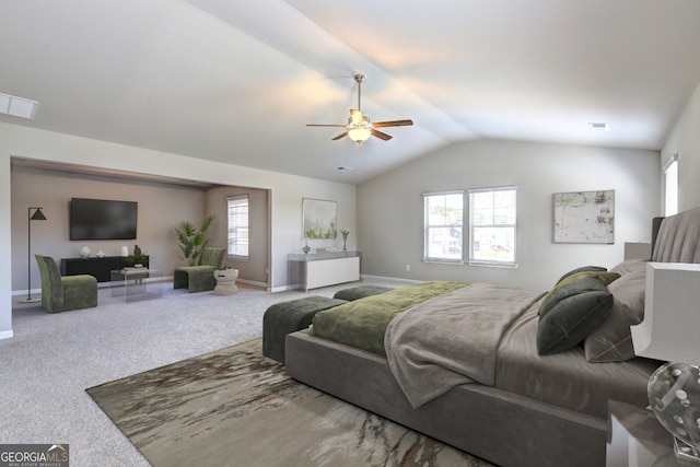 bedroom with ceiling fan, lofted ceiling, carpet flooring, and multiple windows