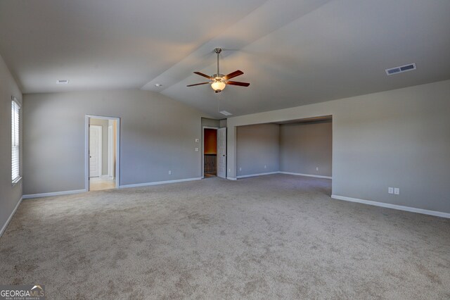 carpeted empty room with lofted ceiling and ceiling fan