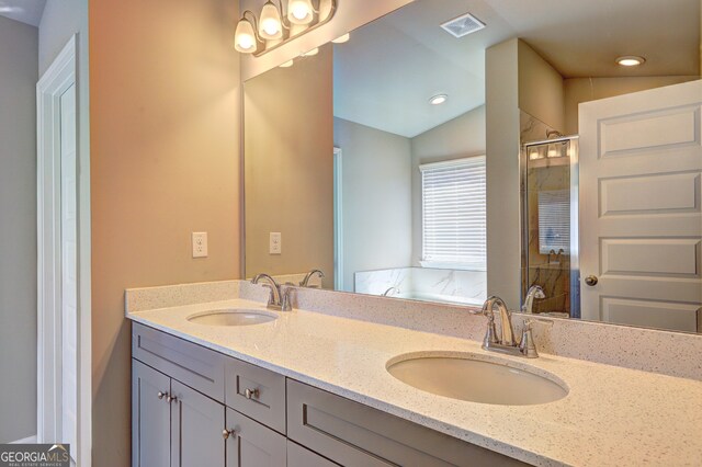 bathroom featuring lofted ceiling, a shower with door, and vanity