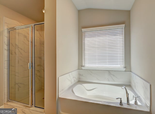 bathroom with vaulted ceiling and independent shower and bath