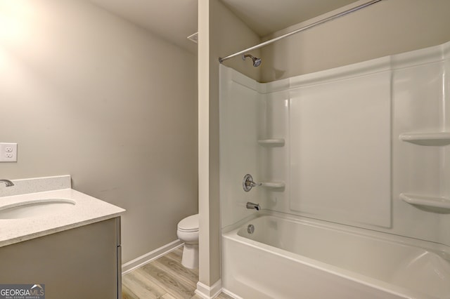 full bathroom with wood-type flooring, shower / bathtub combination, vanity, and toilet