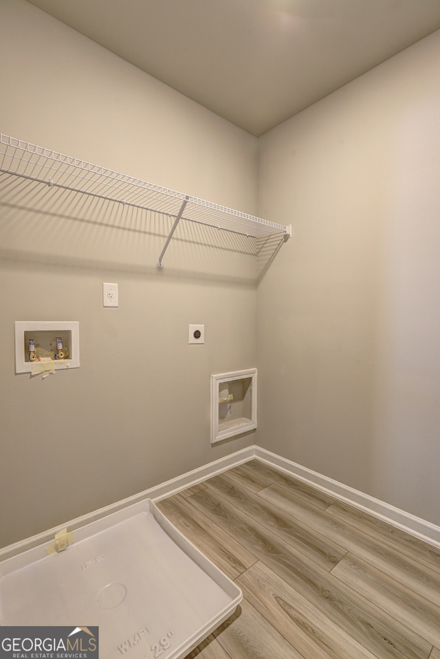 laundry room with wood-type flooring, hookup for an electric dryer, and hookup for a washing machine