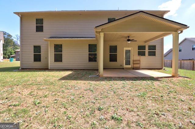 rear view of house with a patio, ceiling fan, and a yard