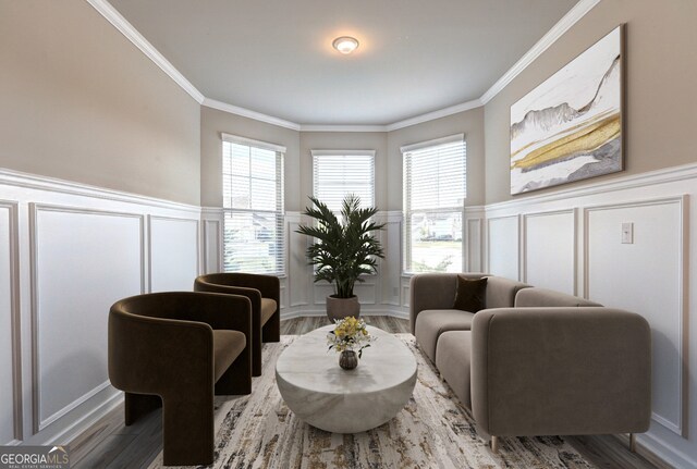 sitting room featuring wood-type flooring and crown molding