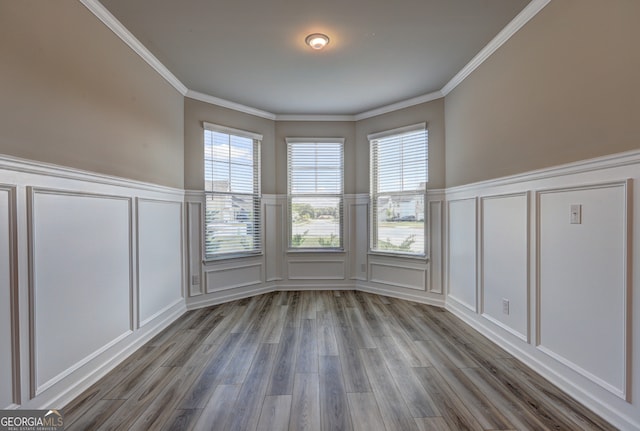 unfurnished dining area featuring light wood-type flooring and ornamental molding