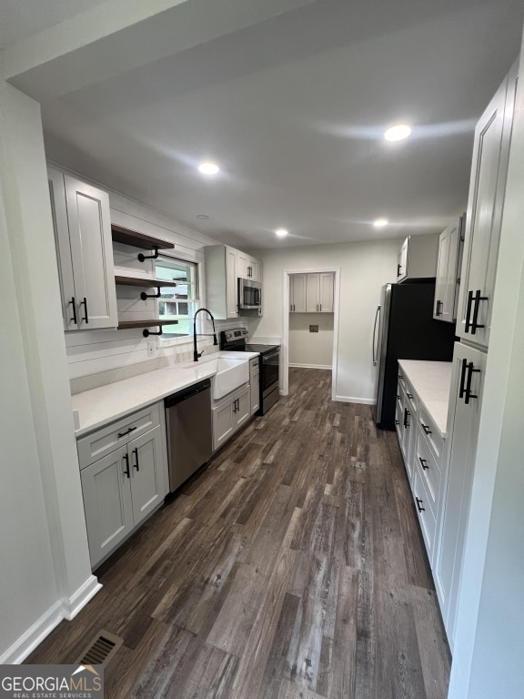 kitchen featuring stainless steel appliances, dark hardwood / wood-style floors, and sink