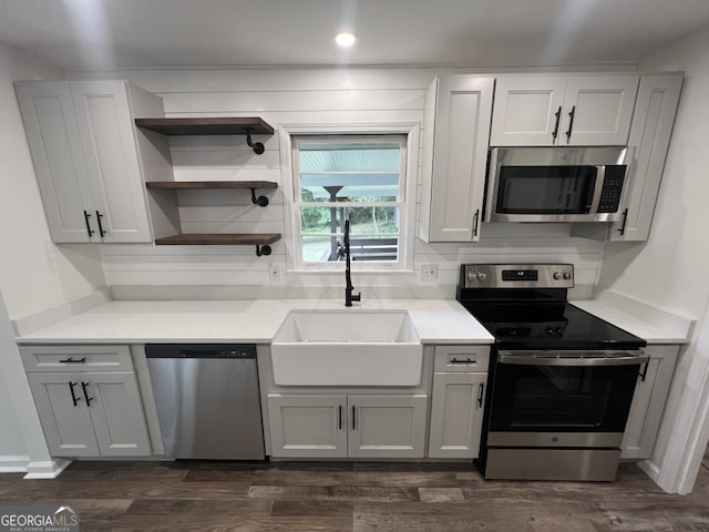 kitchen with stainless steel refrigerator with ice dispenser, dark hardwood / wood-style floors, and white cabinetry