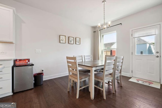 dining space featuring a chandelier and dark hardwood / wood-style flooring