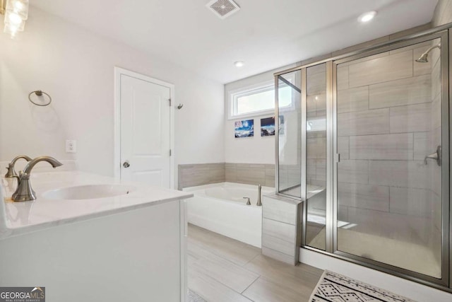 bathroom featuring sink, plus walk in shower, and tile patterned floors