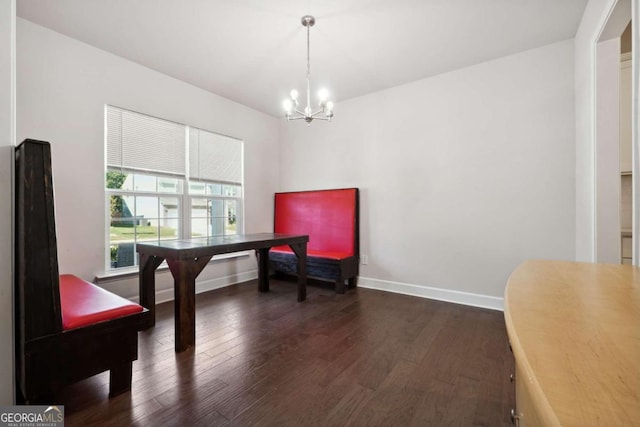 living area featuring an inviting chandelier and dark hardwood / wood-style flooring