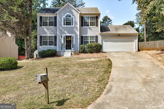 colonial-style house featuring a front yard and a garage