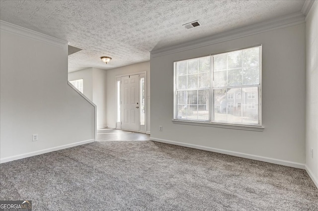 interior space featuring a textured ceiling, ornamental molding, and a wealth of natural light