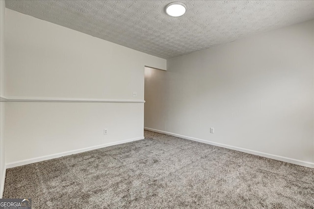 empty room with a textured ceiling and carpet