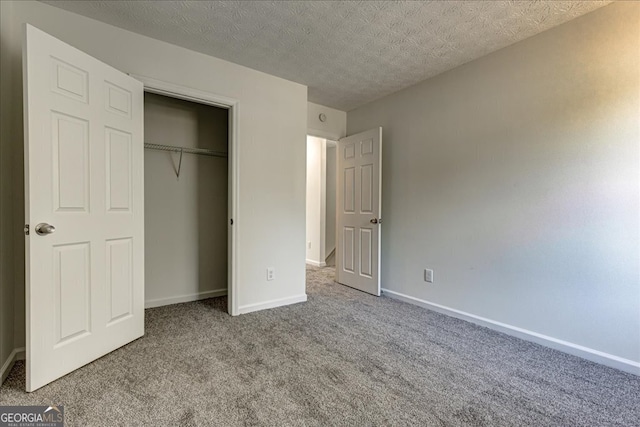 unfurnished bedroom featuring a closet, carpet, and a textured ceiling