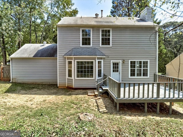 back of house with a wooden deck and a yard