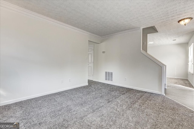 carpeted empty room with a textured ceiling and crown molding