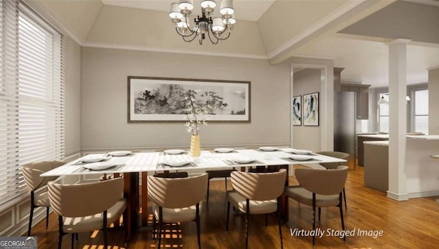 dining space with an inviting chandelier, lofted ceiling, hardwood / wood-style floors, and a healthy amount of sunlight