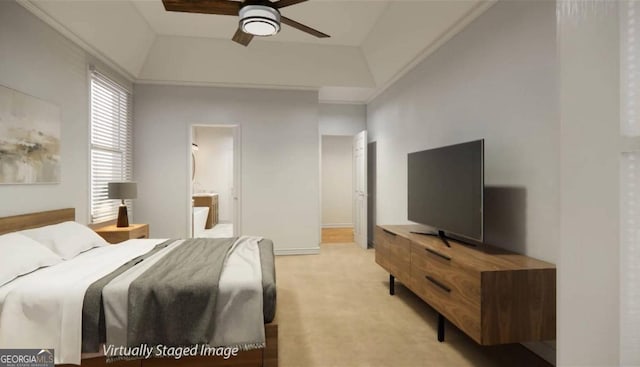 carpeted bedroom with connected bathroom, a tray ceiling, and ceiling fan