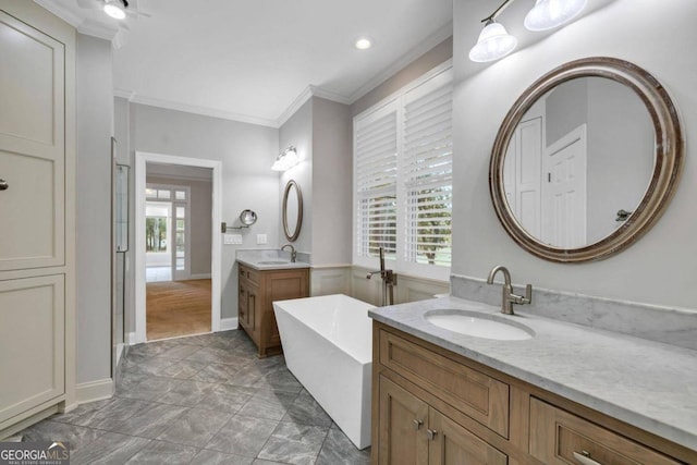 bathroom featuring vanity, a bathtub, and ornamental molding