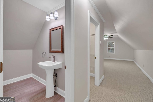 bathroom featuring vaulted ceiling, hardwood / wood-style floors, and sink