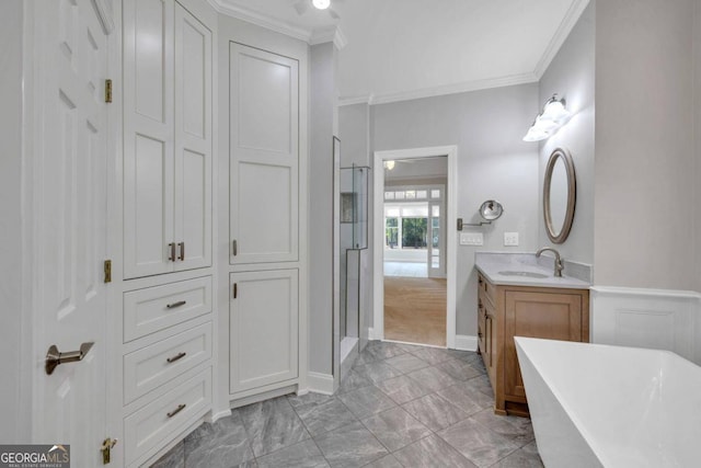 bathroom featuring plus walk in shower, vanity, and crown molding