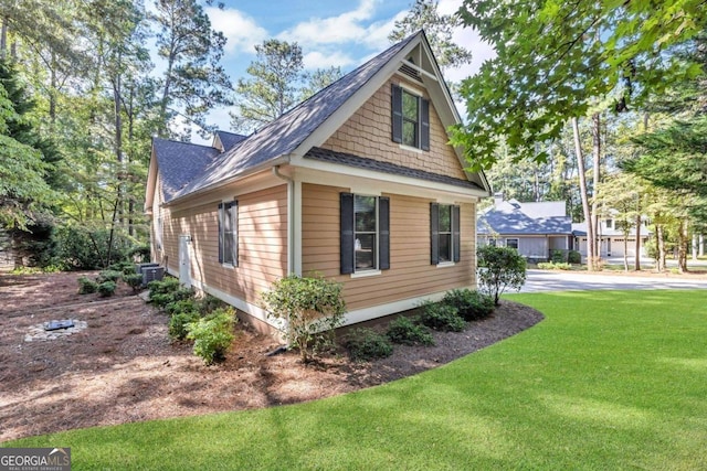 view of side of property with a lawn