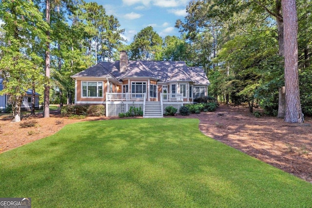 single story home featuring a front yard and a deck