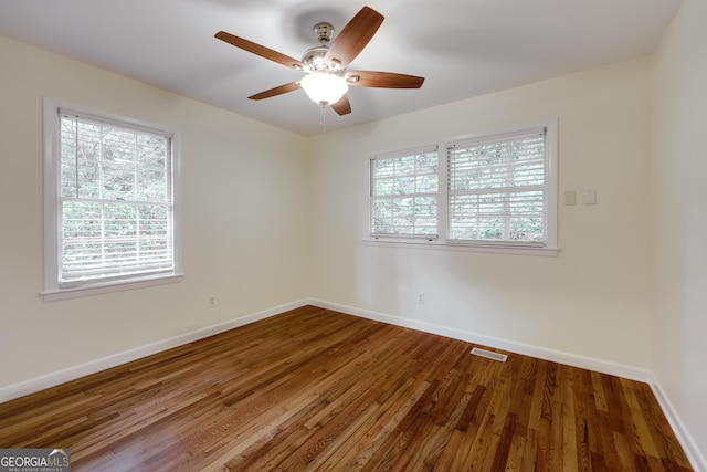 unfurnished room with hardwood / wood-style flooring and ceiling fan