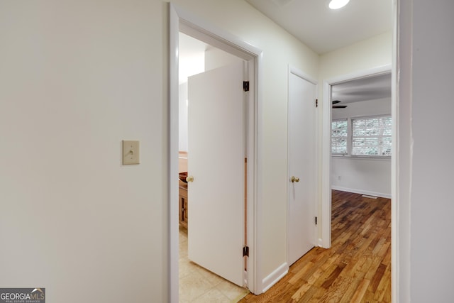 corridor with light hardwood / wood-style flooring