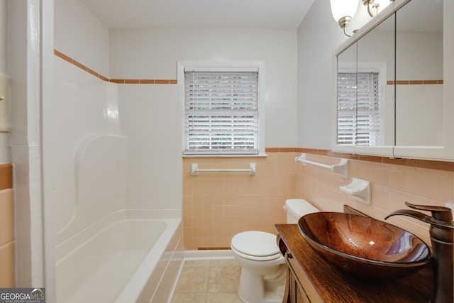 bathroom featuring vanity, tile walls, tile patterned floors, and toilet