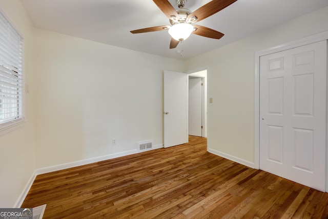 unfurnished bedroom featuring hardwood / wood-style flooring and ceiling fan