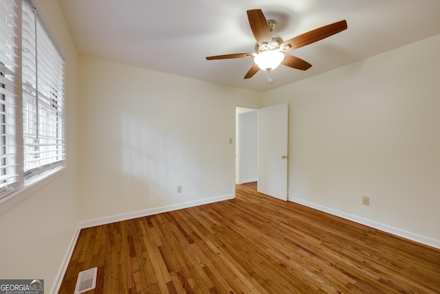 spare room with ceiling fan and hardwood / wood-style floors