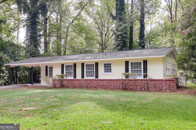 single story home with a front lawn and a carport