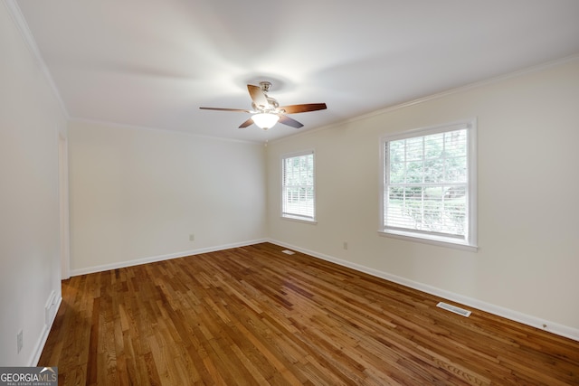 spare room featuring hardwood / wood-style floors, crown molding, and ceiling fan